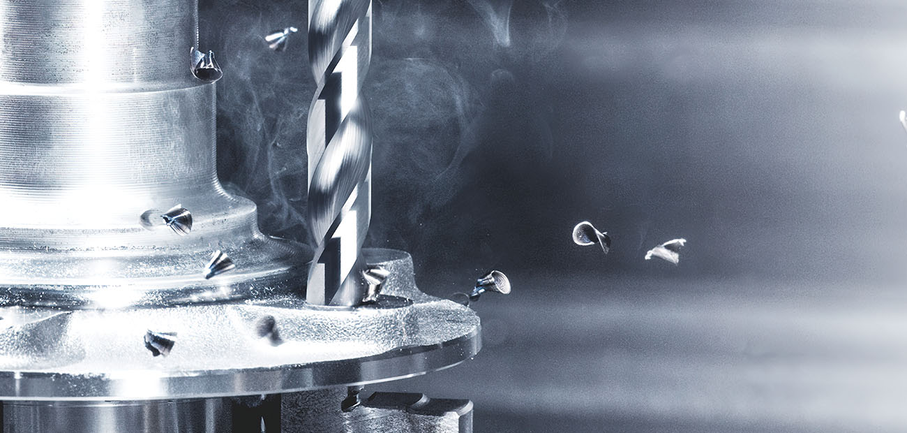 Drilling tool in use with flying metal chips during machining