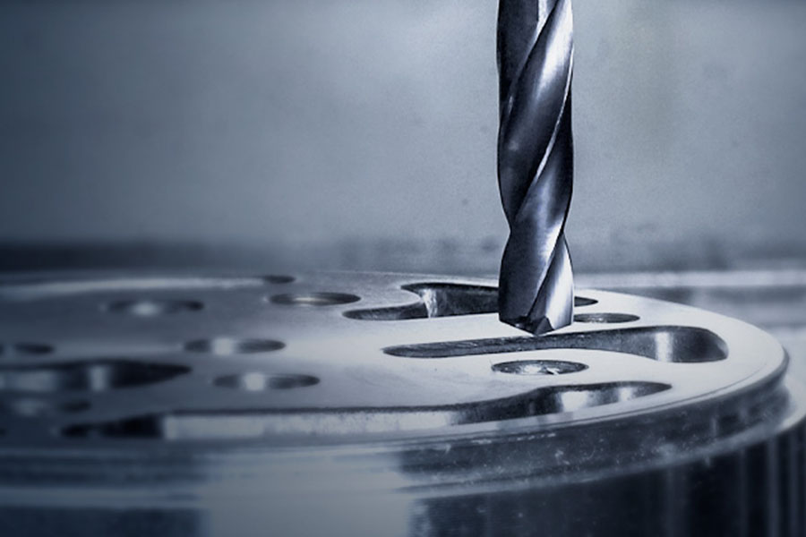 HSS drill in use, drilling a hole in a metal component