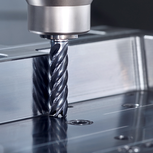 Milling cutter in action during the milling process of a metal workpiece in tool and mould making