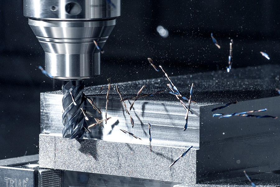 A milling tool in action, removing material from a workpiece in an industrial environment