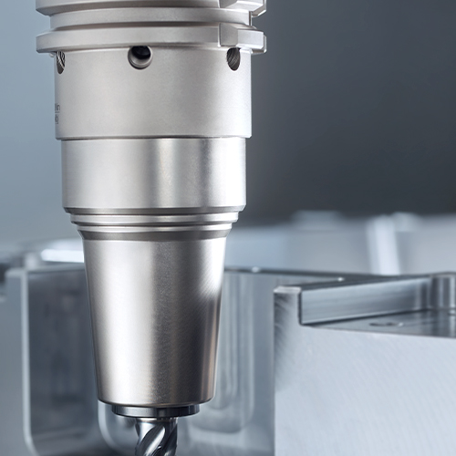 Milling cutter in a clamping device for machining a metal part in tool and mould making