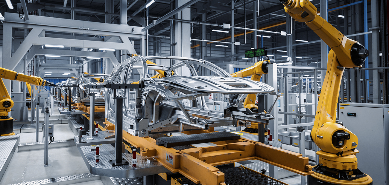 Automotive production line with yellow industrial robots working on the assembly of car bodies