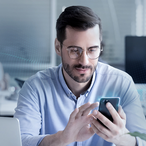 Businessman with glasses uses smartphone to use digital services