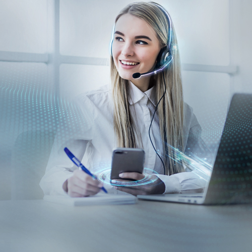 Customer service employee with headset uses a smartphone and writes notes