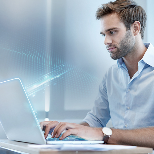employees on a laptop with glowing digital interfaces