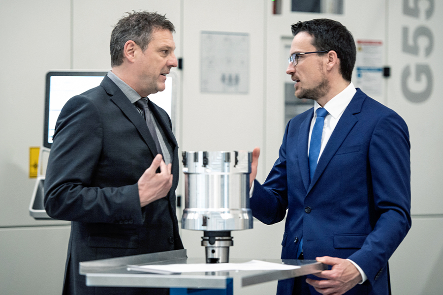 Executives discuss details in an electrical manufacturing environment