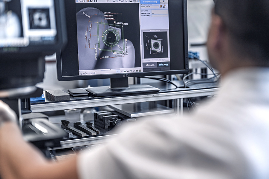 Engineer in tool development works with an optical microscope