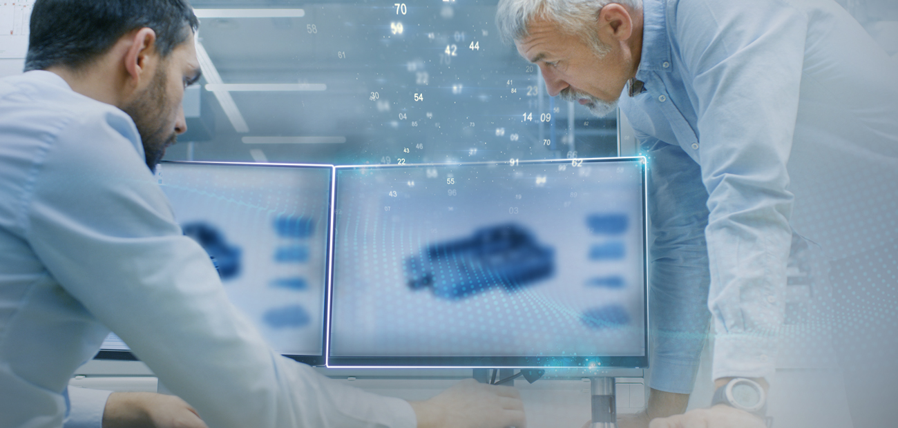 Two engineers analyse a digital 3D model