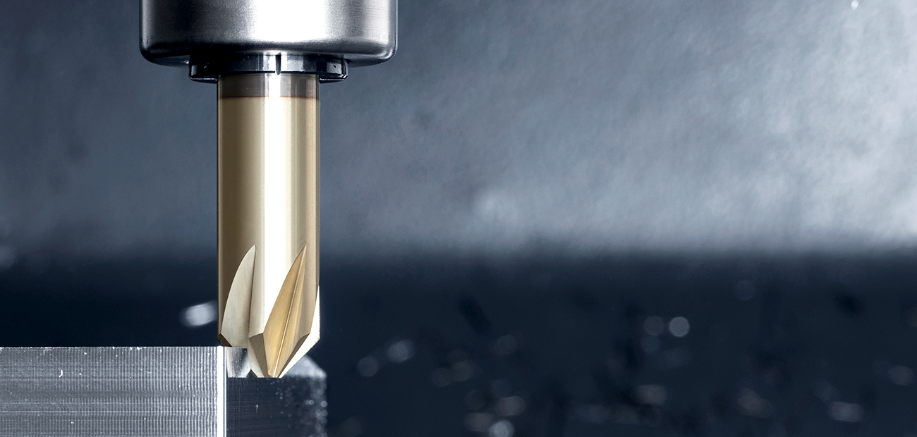 Deburring tool in action, applied to the edge of a metal workpiece
