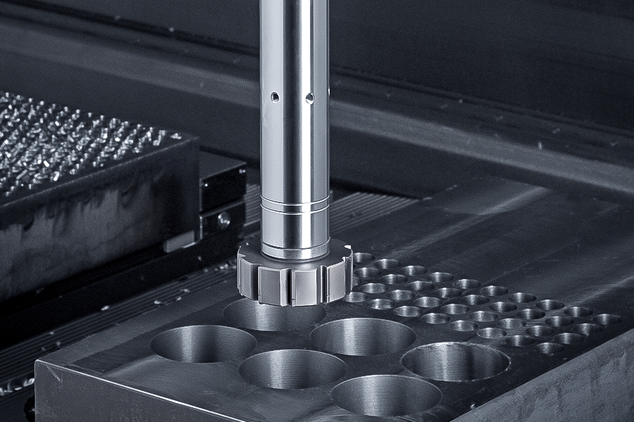 Reamer in a CNC machine currently machining a hole in a metal block