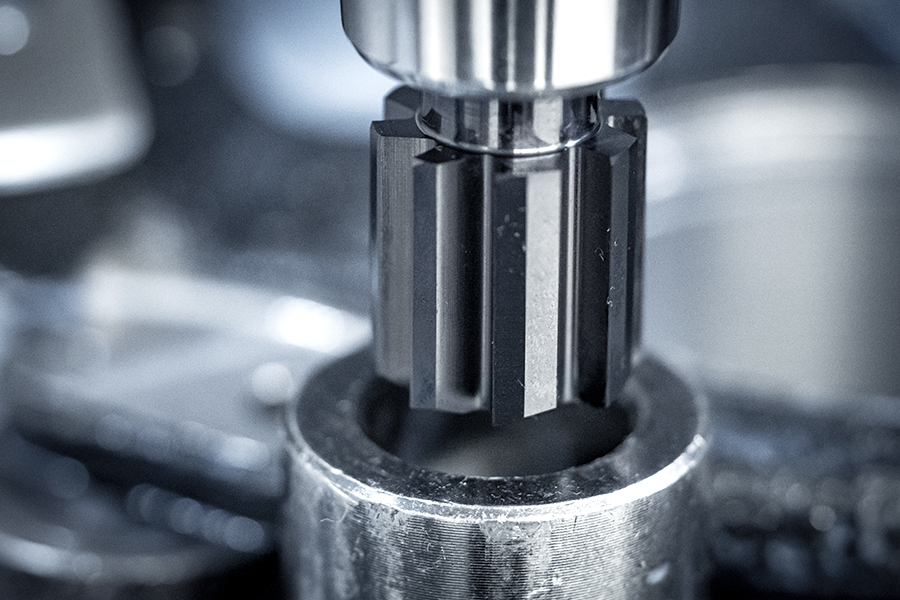 Macro photograph of a reamer in use on a metal hole