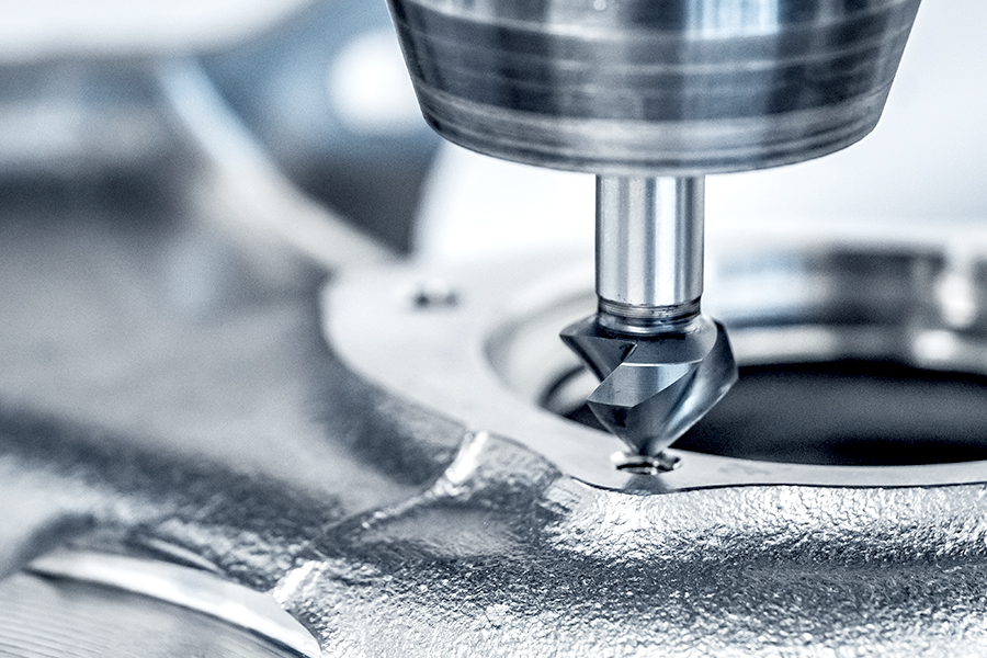 CNC machine with clamped countersink tool precisely machining a metal component