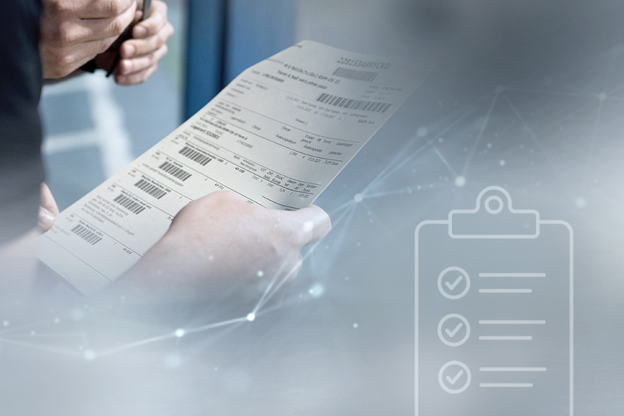 Employee checks a detailed production order with barcodes