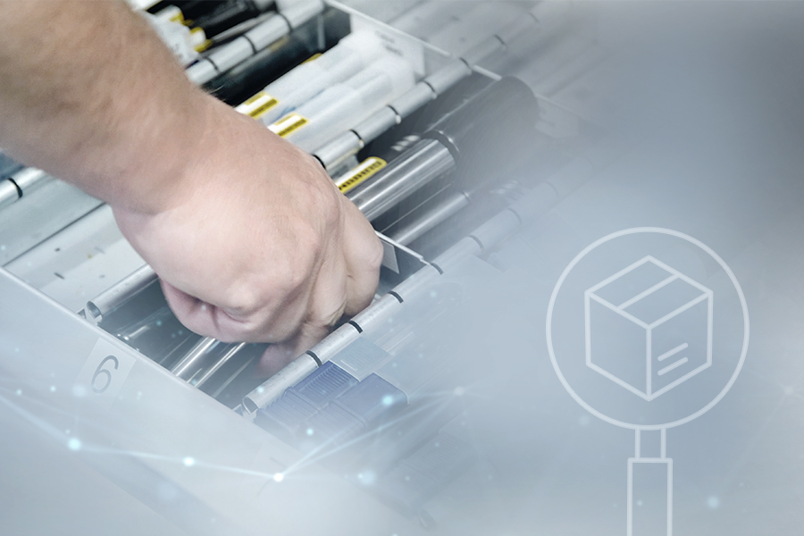 A person removes a tool from a numbered compartment of an automated tool management system