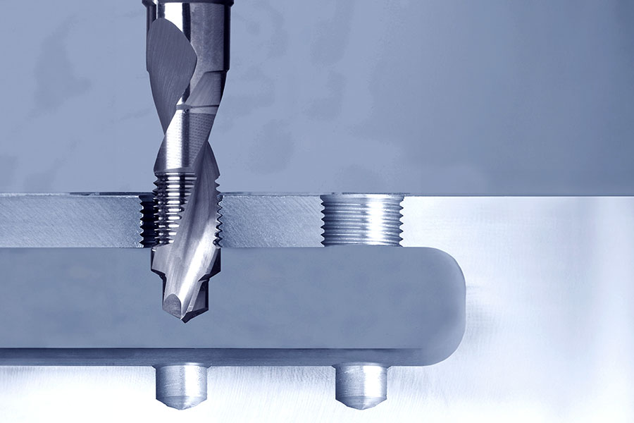 Cross-sectional view of a drill thread milling cutter in use, cutting precise threads into a metal workpiece
