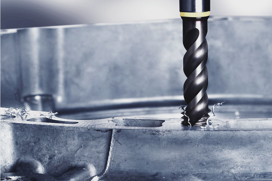 Tap in use, precisely cutting a thread into a metal surface, with chips produced during the process