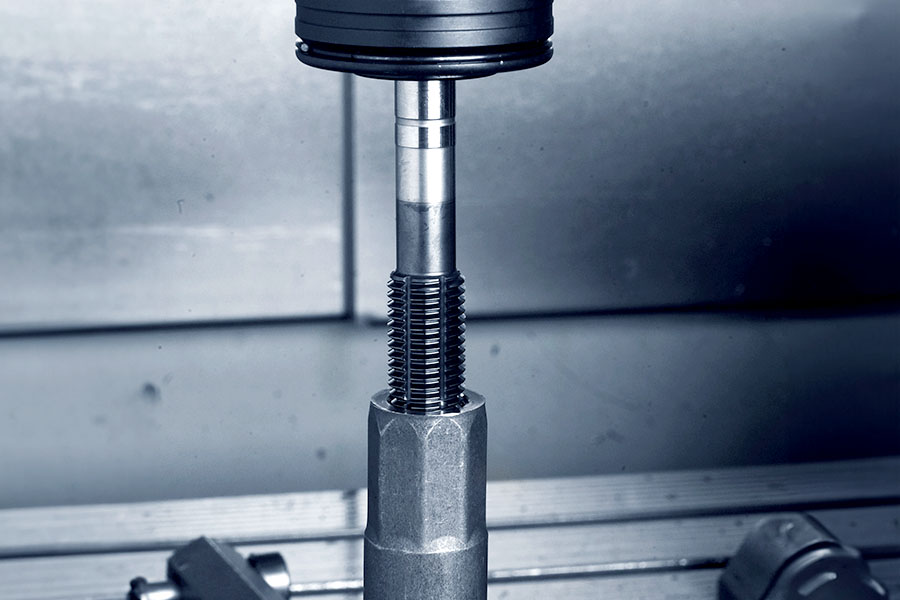 Fluteless tap cutting an internal thread into a metal component